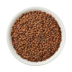 Uncooked lentils in a bowl isolated on white background