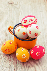 Colorful Easter eggs on wooden background