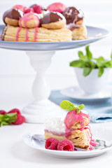 Saint-Honore cake with chocolate and raspberry