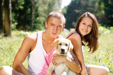 Couple With Their Puppy.