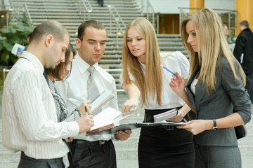 Portrait of businesspeople standing in the office  into folder