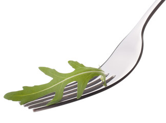 Fresh rucola  salad on fork isolated on white background cutout.