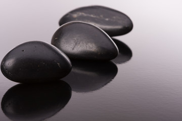 Fototapeta na wymiar Spa stone arrangement on black surface