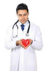 Male doctor with stethoscope holding heart