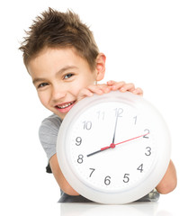 Boy is holding big clock