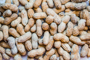 Roasted peanuts on white wooden background