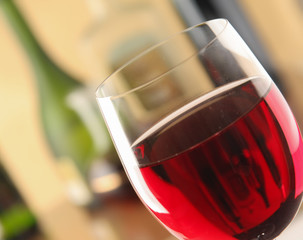 glass of red wine and the wine bottle.