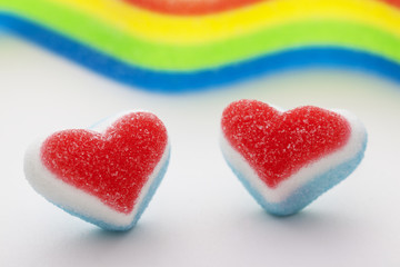 Fototapeta na wymiar Two candy hearts with a rainbow flag