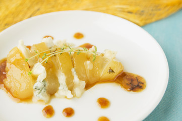 Caramelized pear slices cutting with gorgonzola