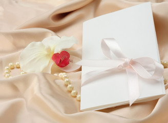 Invitation card on silk satin background.