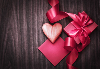 REd Holidays gift and heart on wooden background/ Valentines day