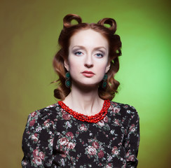 Portrait of girl in retro style with red beads around her neck.