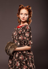 Girl in retro style posing with fur things.