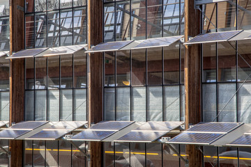 Obraz na płótnie Canvas Solar Panels on the Facade of an Office Building as a Solution f