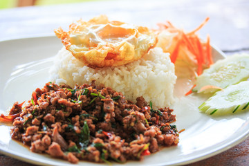 Thai food; Fried mutton with brasil and fried egg over rice