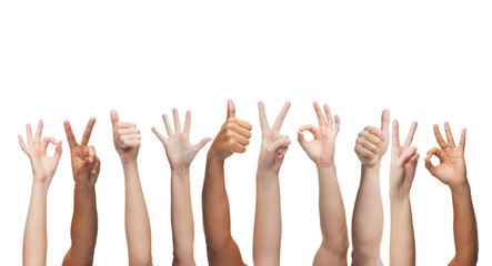 human hands showing thumbs up, ok and peace signs