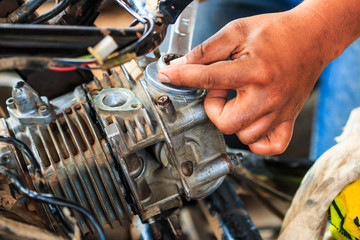 Technician is fixing a part of motorcycle