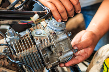 Technician is fixing a part of motorcycle