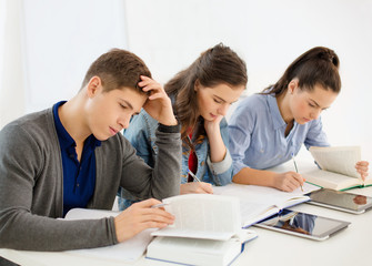 students with notebooks and tablet pc at school