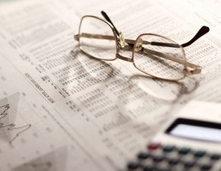 Newspaper and glasses, Calculator.