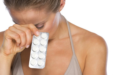 Stressed young woman with pills