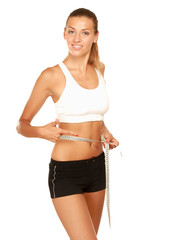 A young woman measuring her waist isolated on white background.