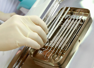 Dental tools on a dentist's chair.