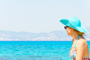 Fototapeta na wymiar Beautiful young woman in swimsuit, relaxing on a sunny beach