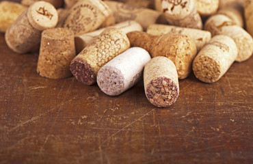 Dated wine bottle corks on the wooden background. Close up