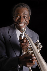 Afroamerikanischer Jazzmusiker mit Flügelhorn lächelt