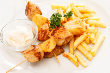 Chicken skewers with french fries