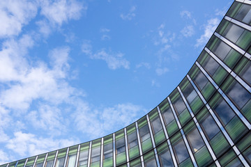 Angled shot of an office building with shiny blue glass