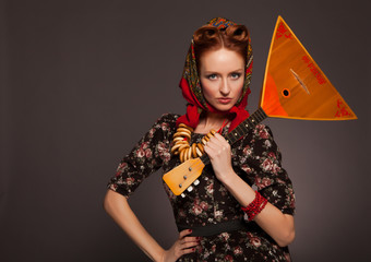 Girl in Russian style posing in red kerchief and bagels on the n - obrazy, fototapety, plakaty