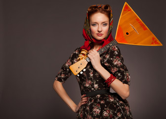 Girl in Russian style posing in red kerchief and bagels on the n