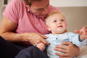 Father Playing With Young Son Indoors