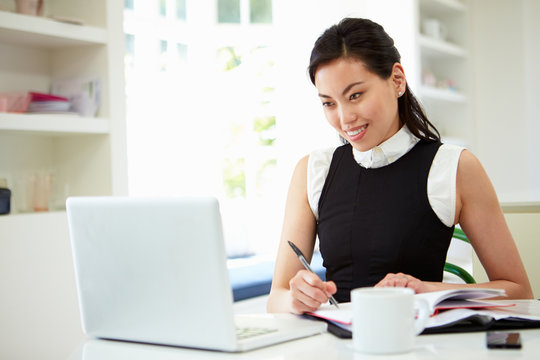 Asian Businesswoman Working From Home On Laptop