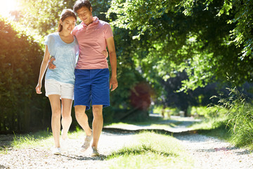 Fototapeta premium Romantic Asian Couple On Walk In Countryside
