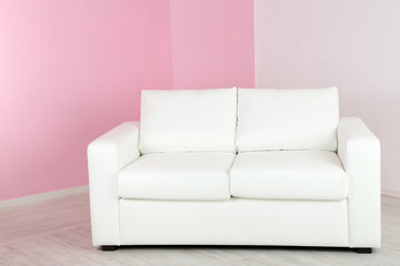 White sofa in room on pink wall background