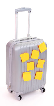 Suitcase with paper stickers isolated on white