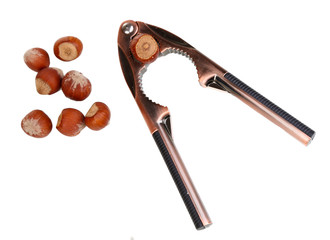 Nutcracker and hazelnuts isolated on white