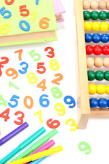 Colorful numbers, abacus, books and markers, isolated on white