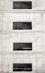 Obraz na płótnie Canvas Building under construction, concrete wall with windows