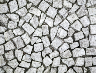 Ancient white stone mosaic closeup background texture
