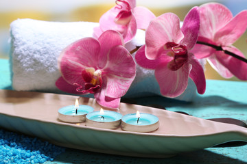 Fototapeta na wymiar Beautiful spa setting with flower on bright background