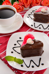 Sweet cakes with chocolate on plate on table close-up