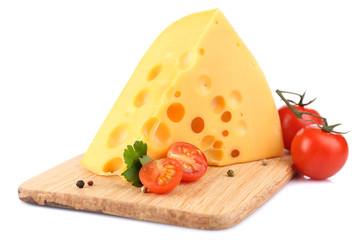 Piece of cheese and tomatoes, on wooden board, isolated on