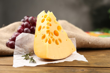 Piece of cheese with grape and rosemary