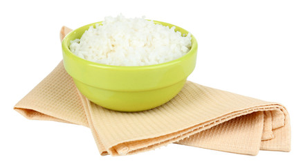 Cooked rice in bowl on napkin isolated on white