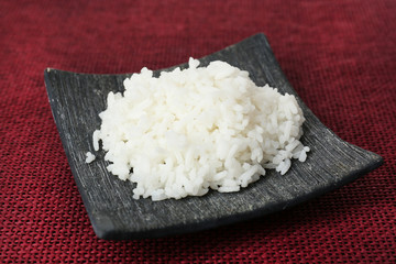 Cooked rice on red background