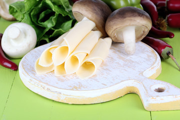 Cream cheese with vegetables and greens on wooden table
